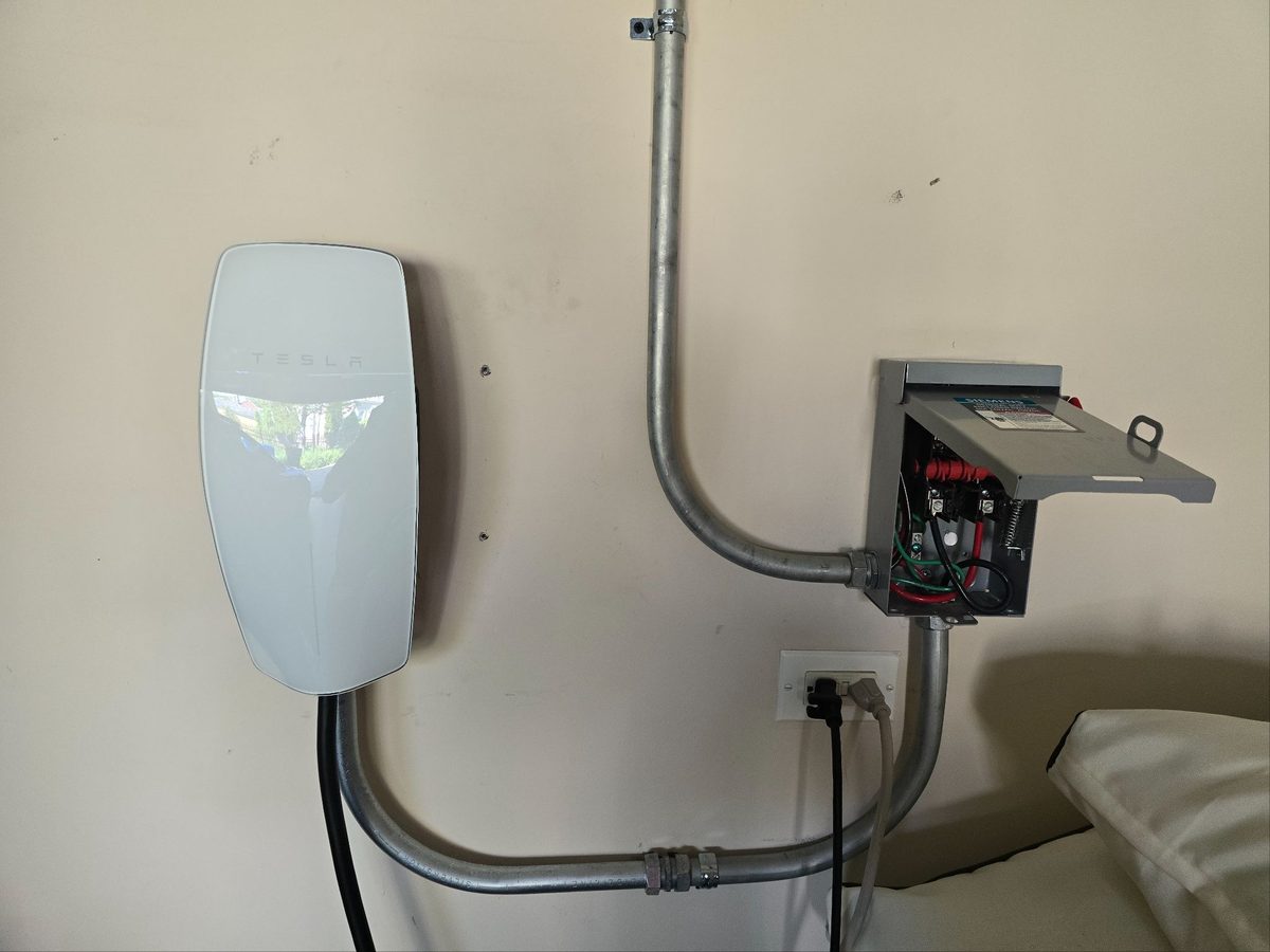 Tesla Wall Connector installed with a dedicated disconnect and conduit