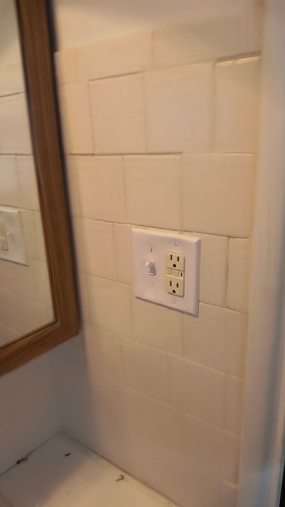 Finished outlet in a freshly tiled bathroom remodel